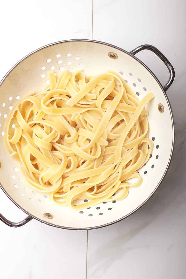 Fettuccine pasta in colander 
