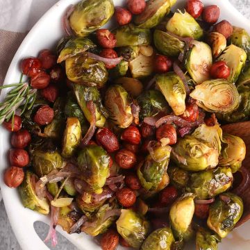 Roasted brussels sprouts and hazelnuts in a white bowl