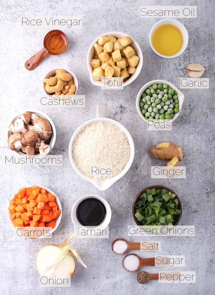 Ingredients for vegan fried rice on a cement countertop