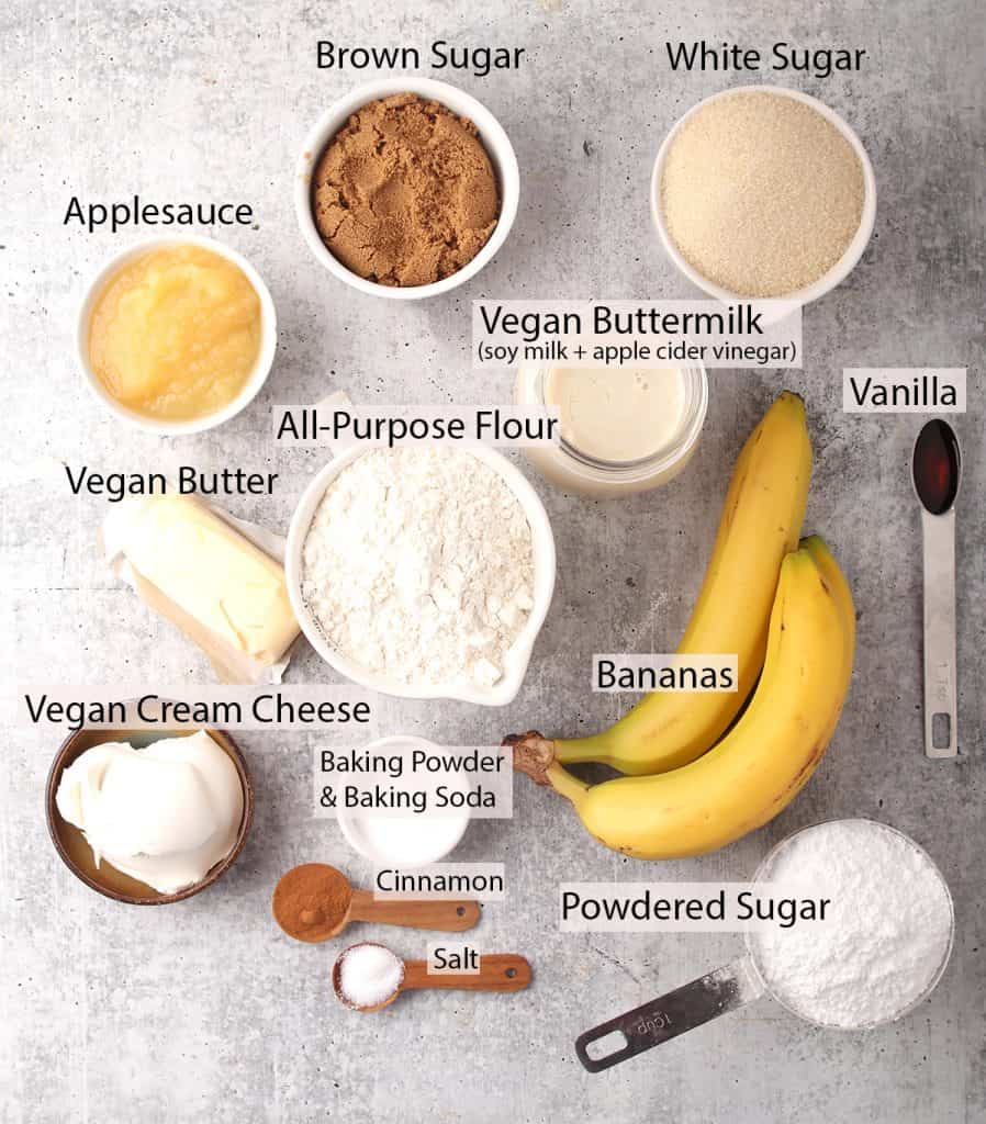 ingredients for making vegan banana cake recipe with cream cheese frosting laid out on a grey table
